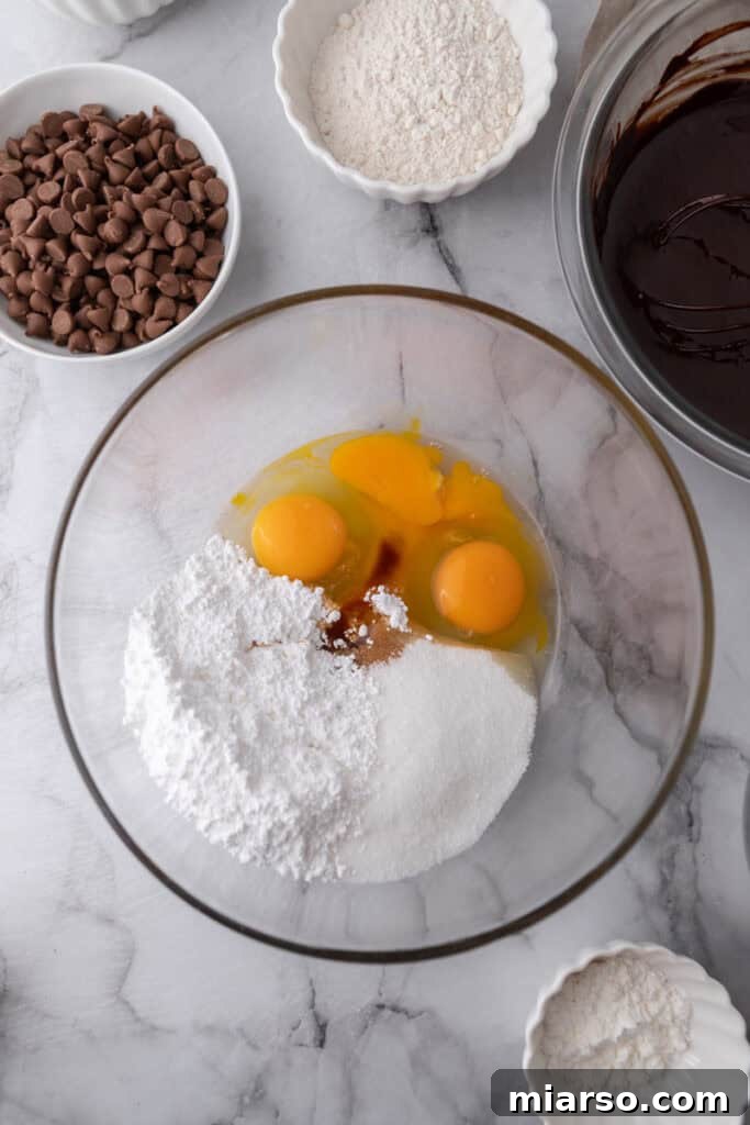 Mastering the World's Best Fudgy Brownies 8 Eggs and sugar in a bowl