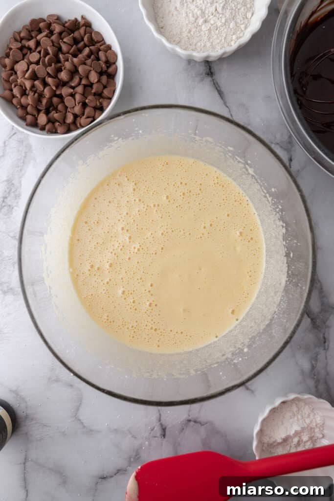 Mastering the World's Best Fudgy Brownies 9 Eggs and sugar in a bowl whipped