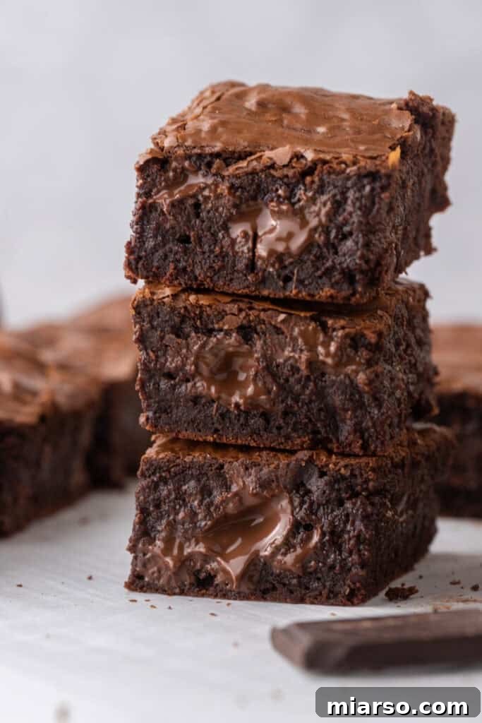 Fudgy Brown Butter Brownies stacked on top of each other