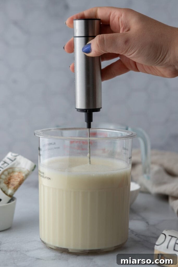 Hand frothing ice cream base in the Ninja Creami pint