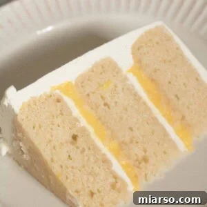 layered vanilla cake with lemon curd and vanilla bean italian meringue buttercream