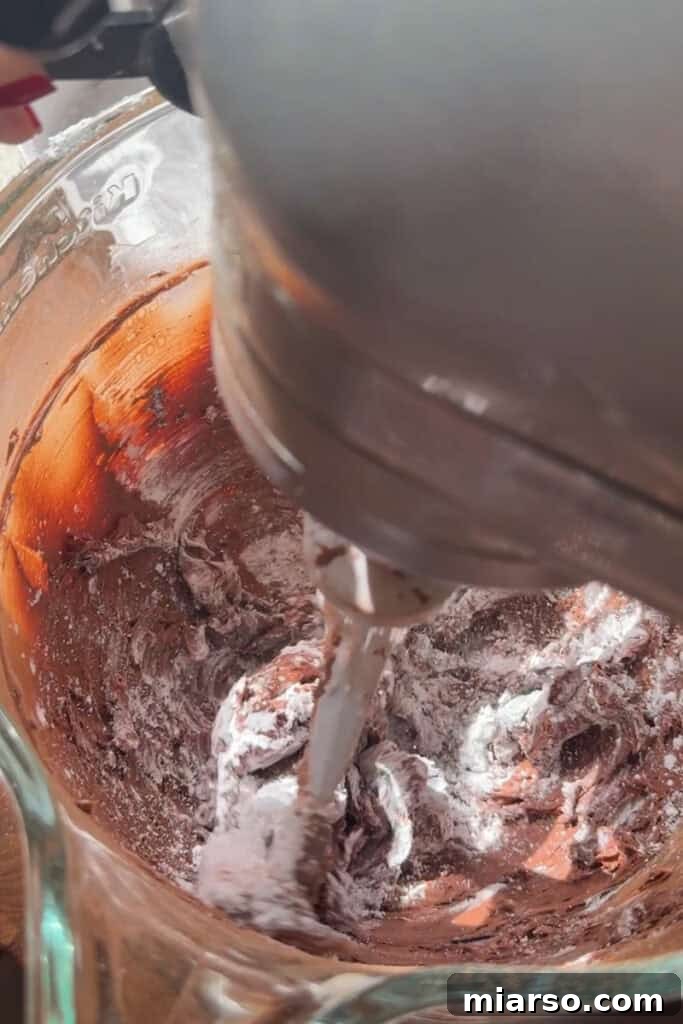 More ingredients being mixed into the chocolate buttercream.