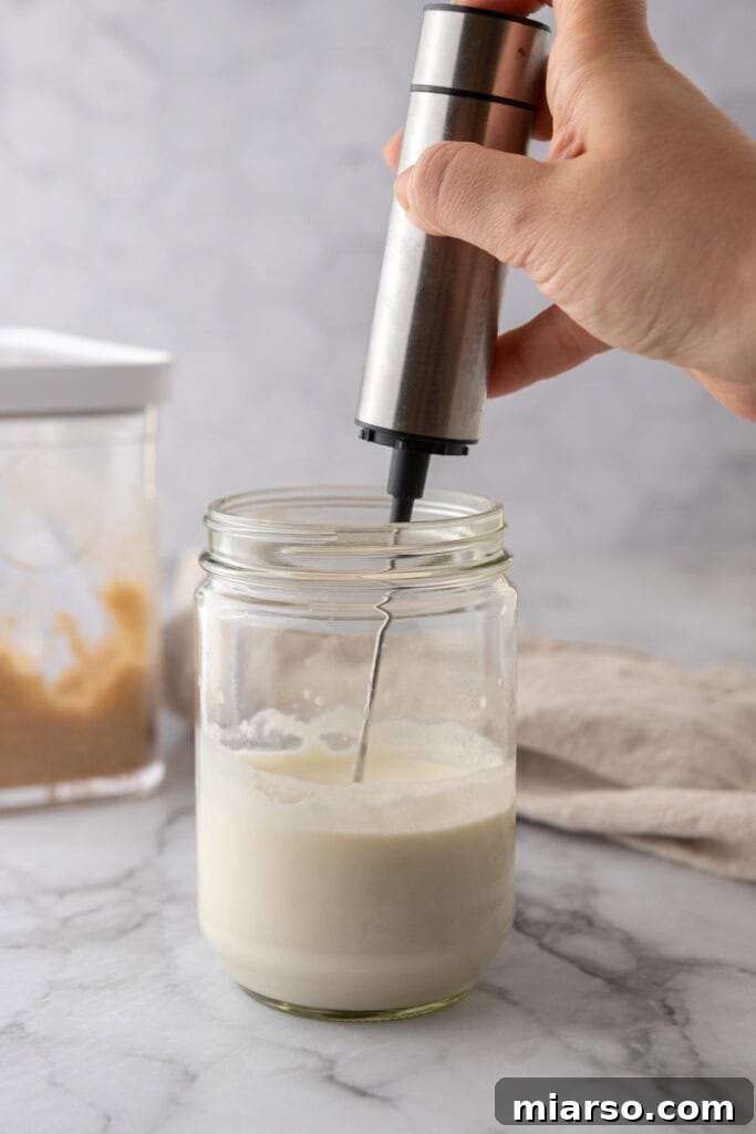 Dairy ingredients in a glass jar getting whipped