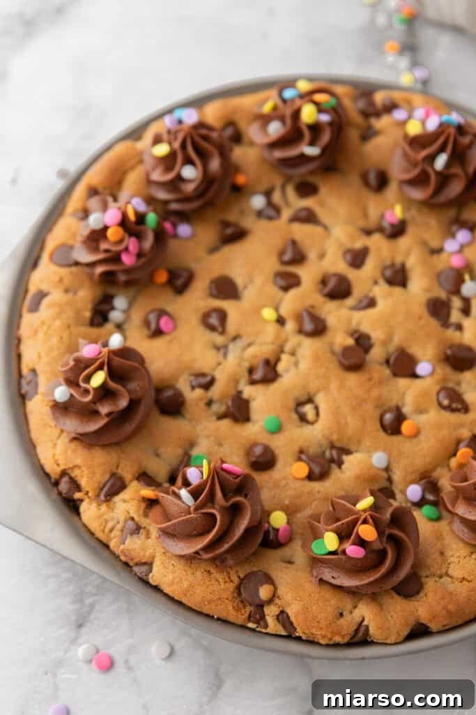 The Ultimate Homemade Chocolate Chip Cookie Cake 13 Decorated chocolate chip cookie cake with frosting swirls