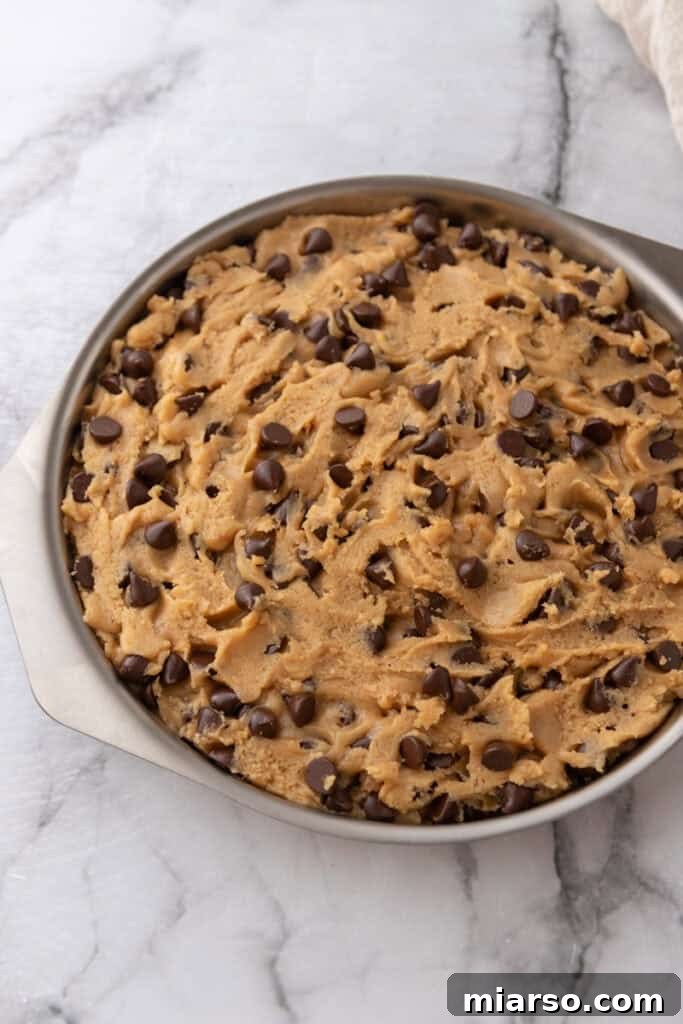 The Ultimate Homemade Chocolate Chip Cookie Cake 10 Cookie dough smoothed in the pan, ready for baking