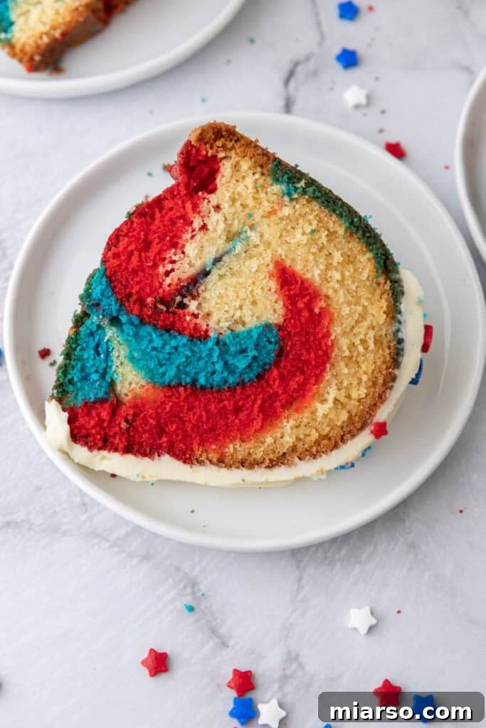 Showstopping Stars and Stripes Bundt Cake 18 Red White and Blue Bundt Cake slice on a plate
