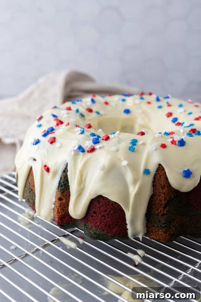 Showstopping Stars and Stripes Bundt Cake 19 fully made red white and blue bundt cake recipe with frosting on it