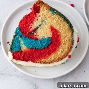 Showstopping Stars and Stripes Bundt Cake 22 Red White and Blue Bundt Cake slice on a plate