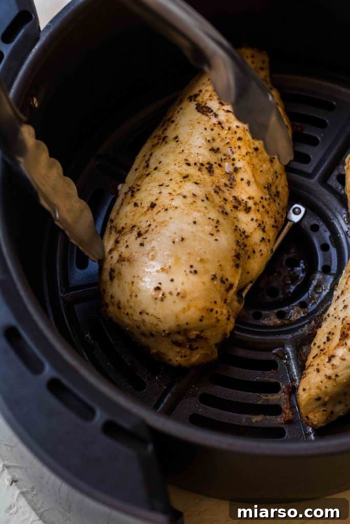 Air fryer chicken breasts in the basket