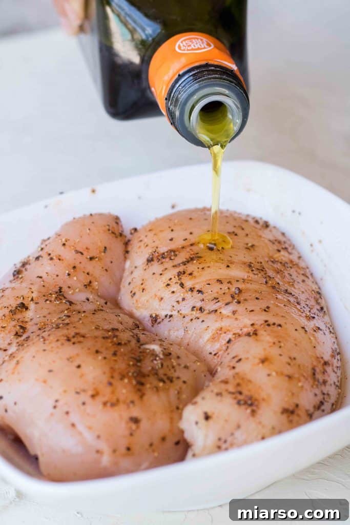 Massaging spices into chicken breast