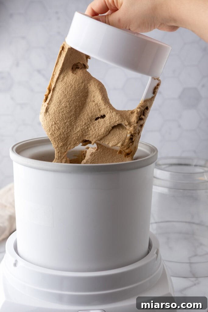 Soft-serve consistency ice cream being scooped out of the machine