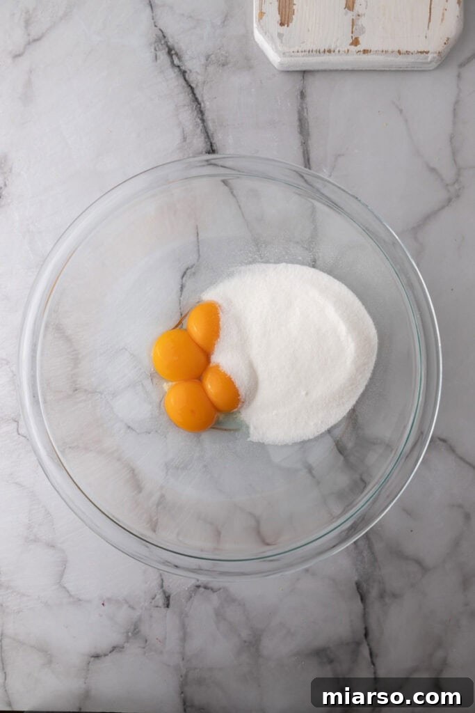 Whisked egg yolks and granulated sugar in a large bowl