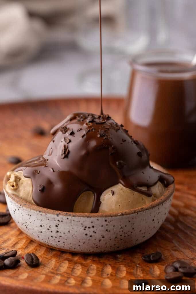 Easy 5-Minute Magic Chocolate Shell for Ice Cream 9 Delicious magic chocolate shell hardening on top of vanilla ice cream in a bowl.