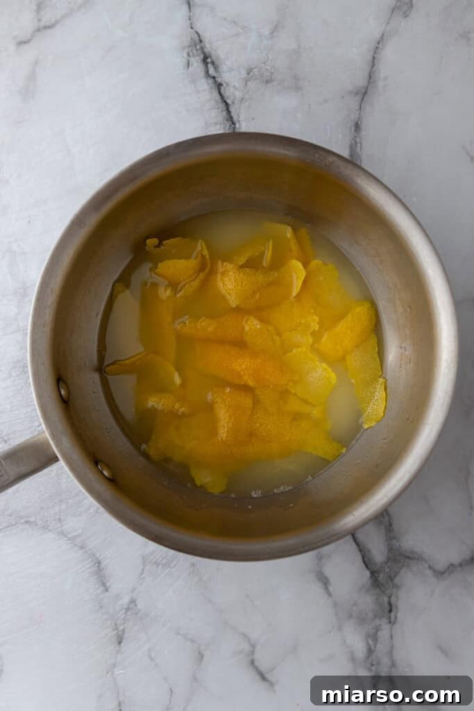 Close-up of lemon simple syrup simmering in a saucepan