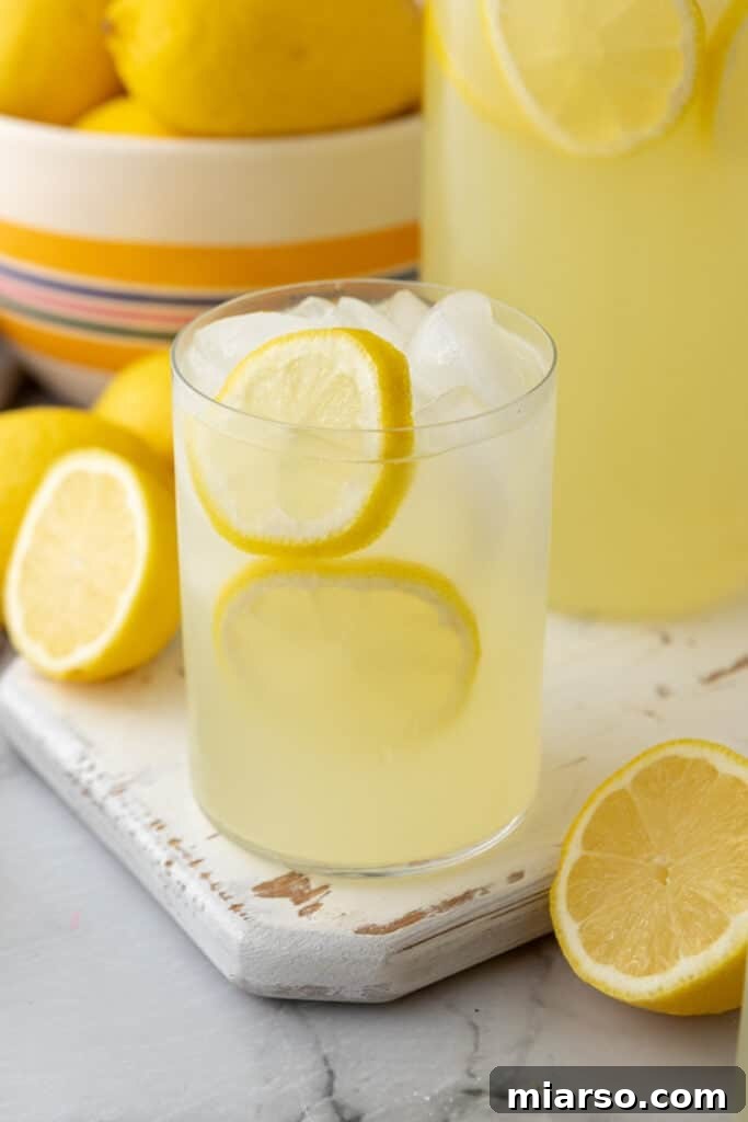 A refreshing glass of homemade lemonade with ice and lemon slices