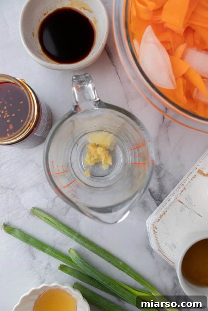 Various dressing ingredients, including liquids and spices, mixed in a measuring cup.