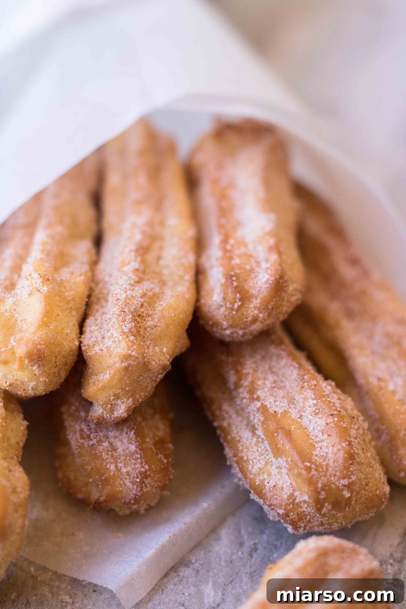 A close-up shot of perfectly air-fried churros, emphasizing their delicious coating and texture.