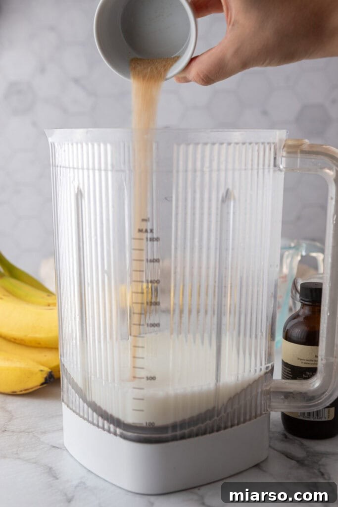 Water being added to a blender for banana milk