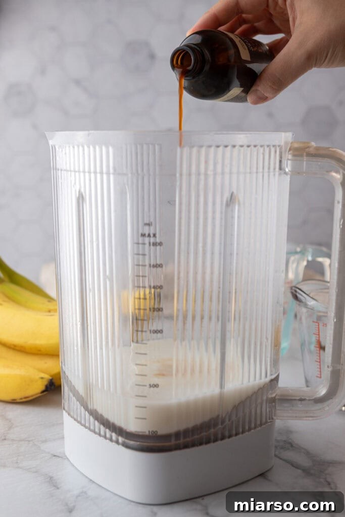 Sweetener being added to a blender for banana milk