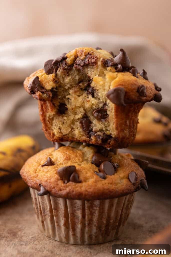 Banana Chocolate Chip Muffins stacked on top of each other