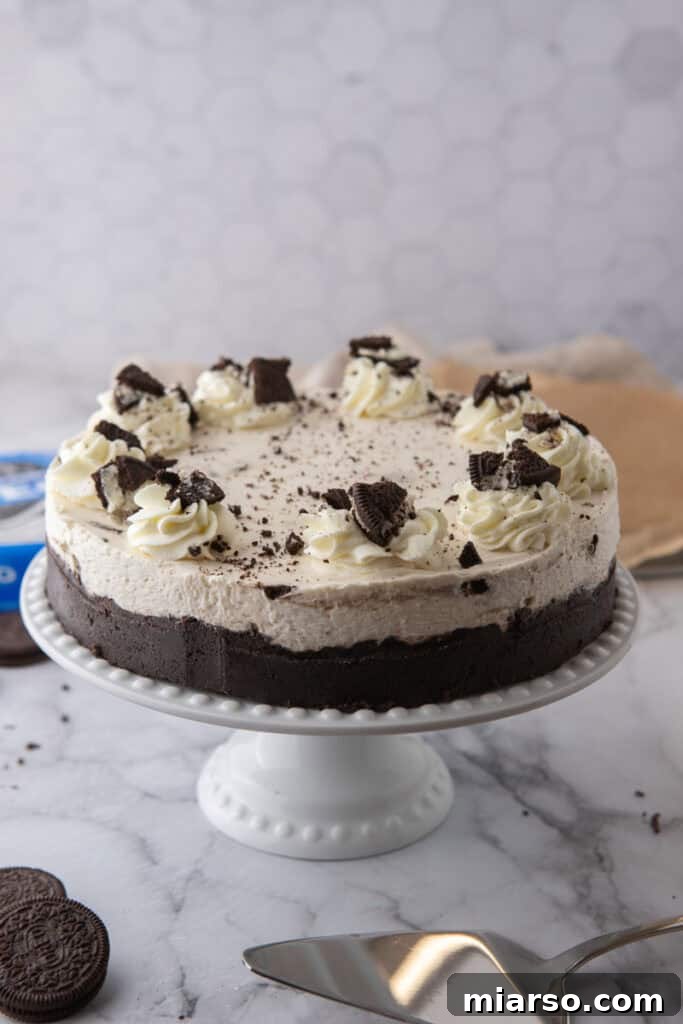 Another view of the finished No Bake Oreo Cheesecake on a stand, ready to be served