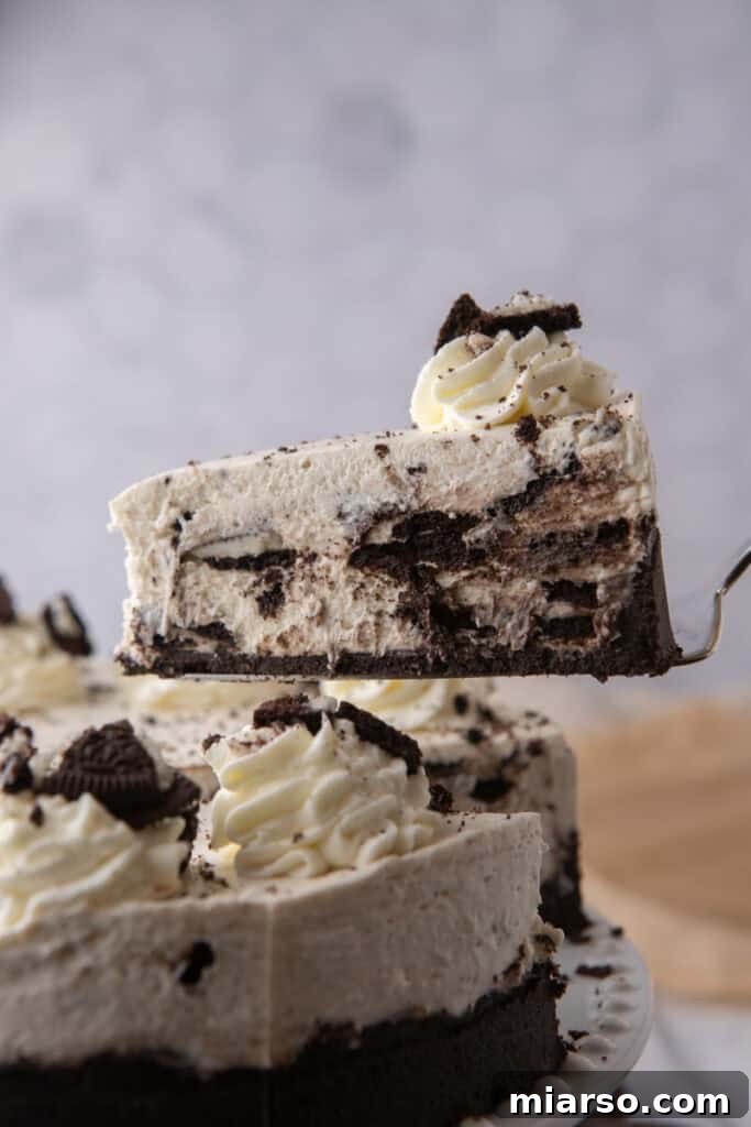 A slice of No Bake Oreo Cheesecake being served on a spatula, highlighting its firm structure