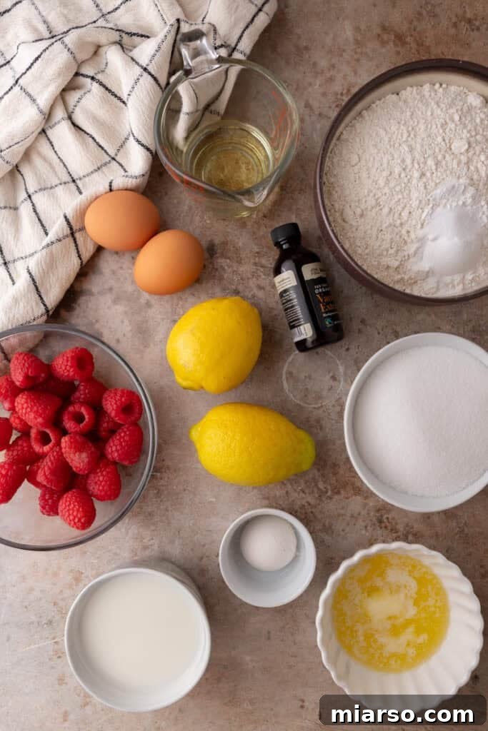 Various ingredients for lemon raspberry muffins laid out on a kitchen counter.