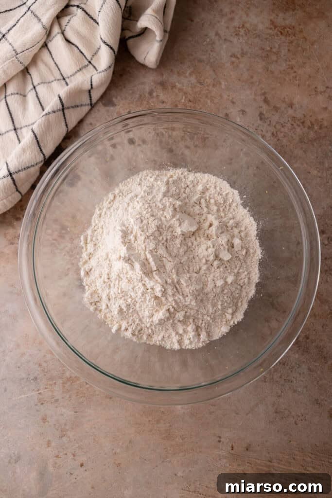 A close-up of dry ingredients mixed with lemon zest and sugar.