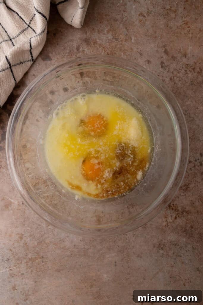 Wet ingredients being poured into the dry ingredients.