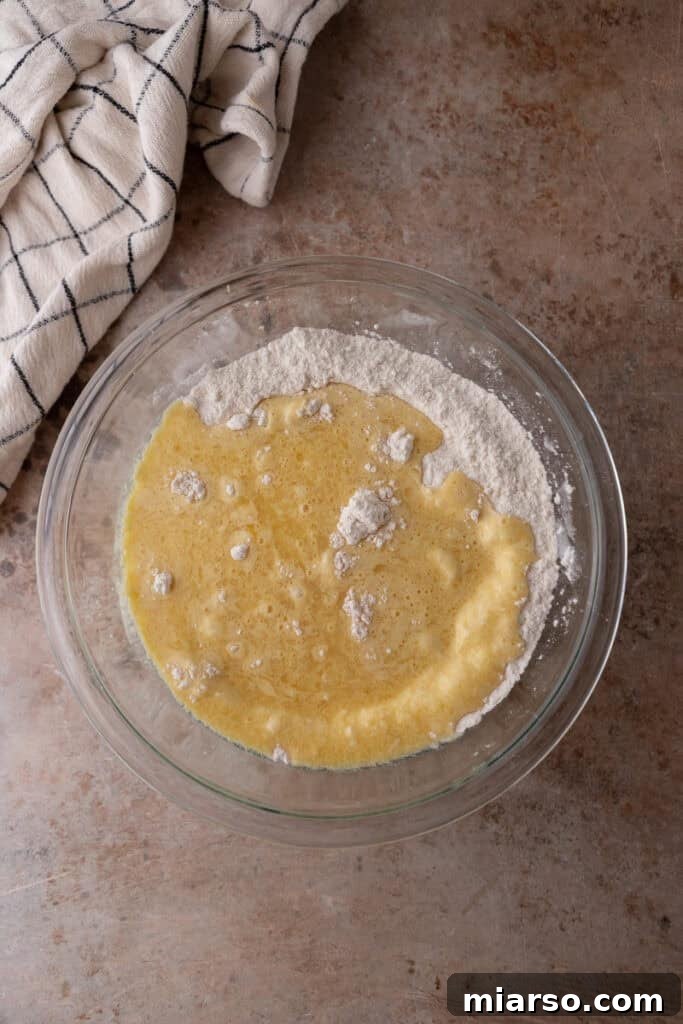 Muffin batter with wet and dry ingredients partially mixed.