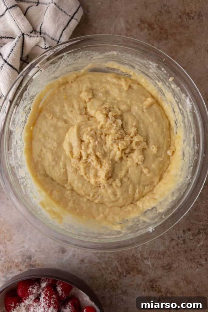 Muffin batter after wet and dry ingredients are just combined, showing a thick, lumpy consistency.