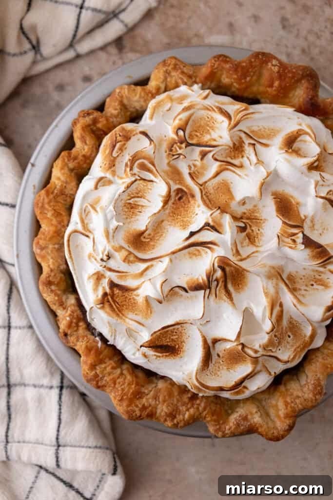 Mastering Chocolate Meringue Pie 18 topping being toasted