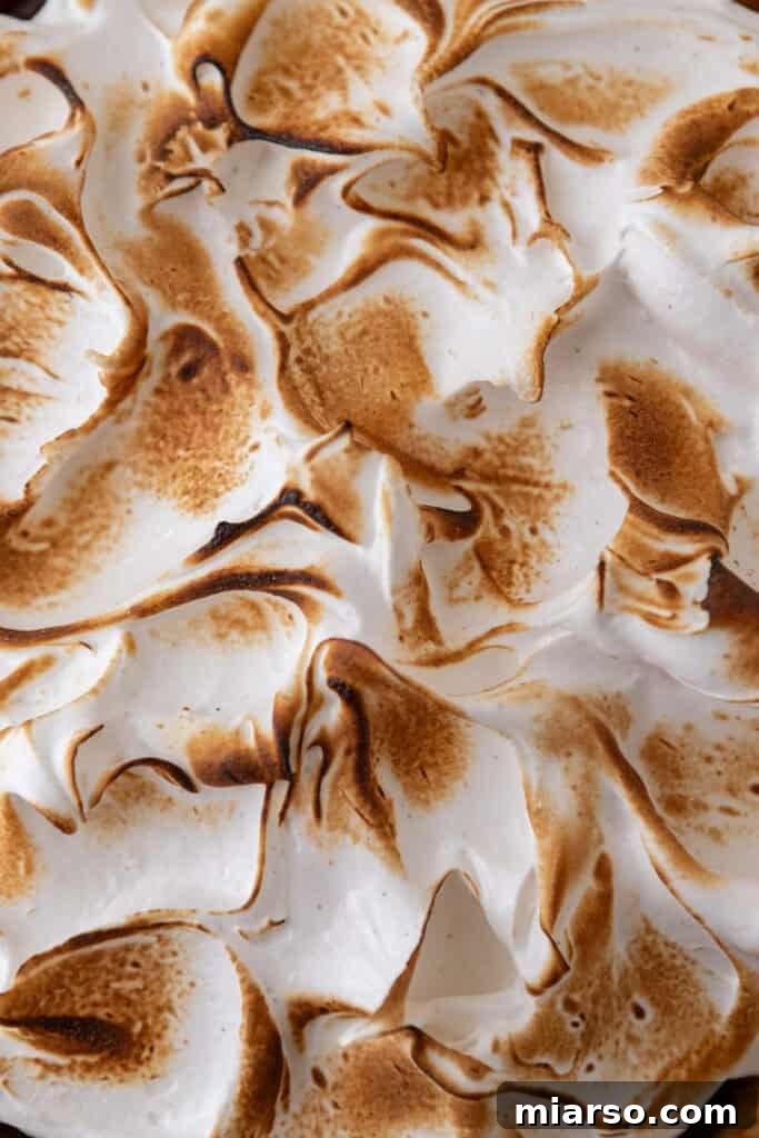Mastering Chocolate Meringue Pie 20 topping being toasted