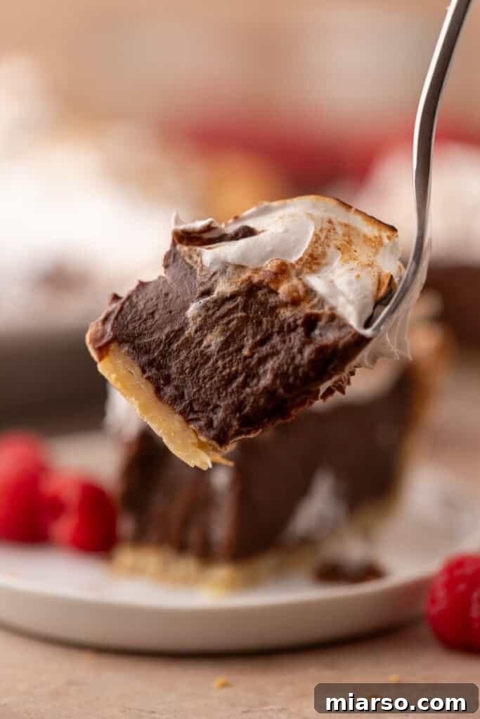 Mastering Chocolate Meringue Pie 22 chocolate meringue pie slice recipe with a piece on a fork