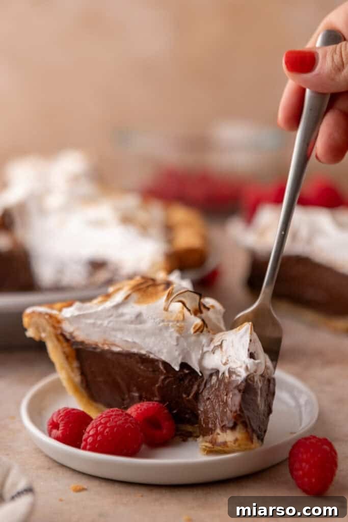 Mastering Chocolate Meringue Pie 24 chocolate meringue pie slice with a fork going in