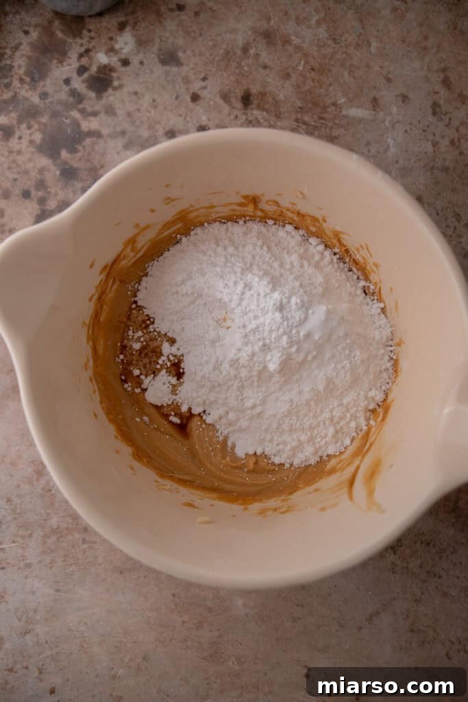 Beating butter and peanut butter until creamy