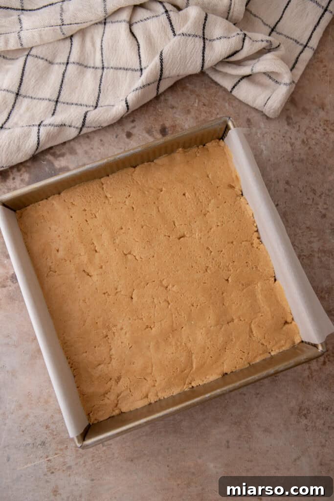Peanut butter layer pressed onto brownies
