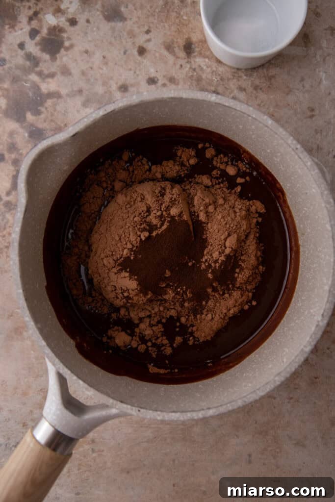 Stirring cocoa and espresso into melted chocolate