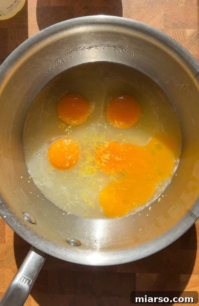 Yuzu curd mixture in a pot over a double boiler