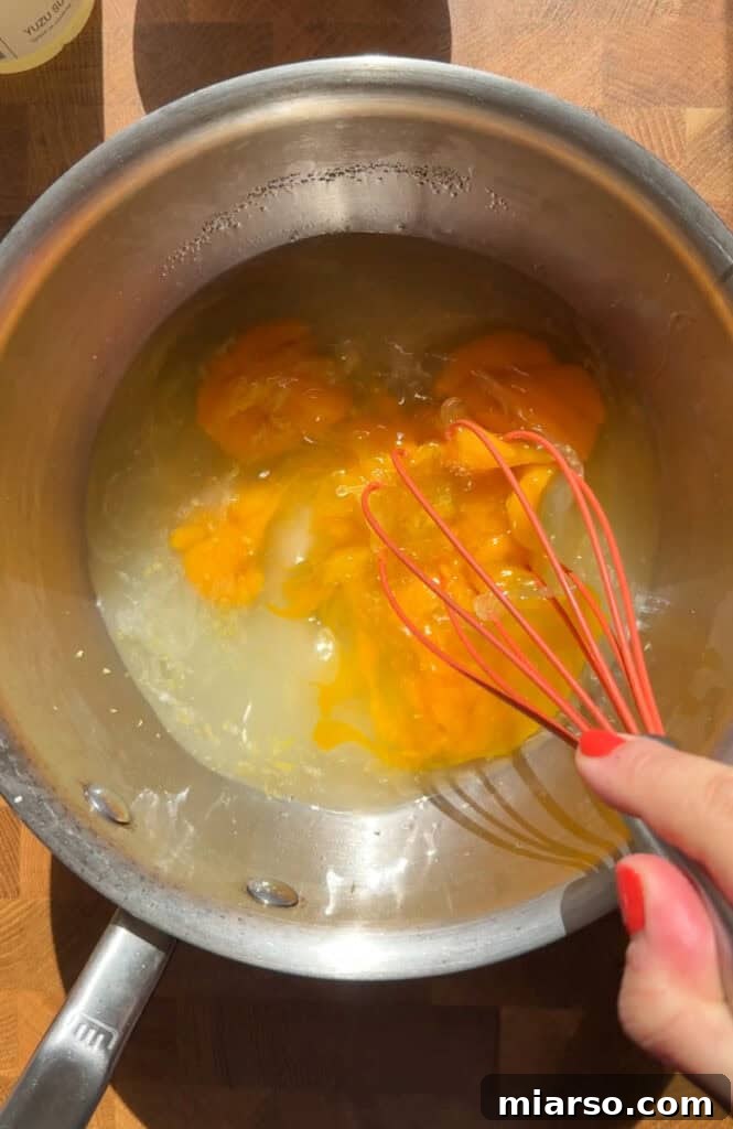 Yuzu curd mixture thickening in a pot
