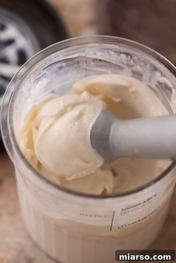 A scoop of high-protein cottage cheese Ninja Creami ice cream being served, emphasizing its readiness to eat.