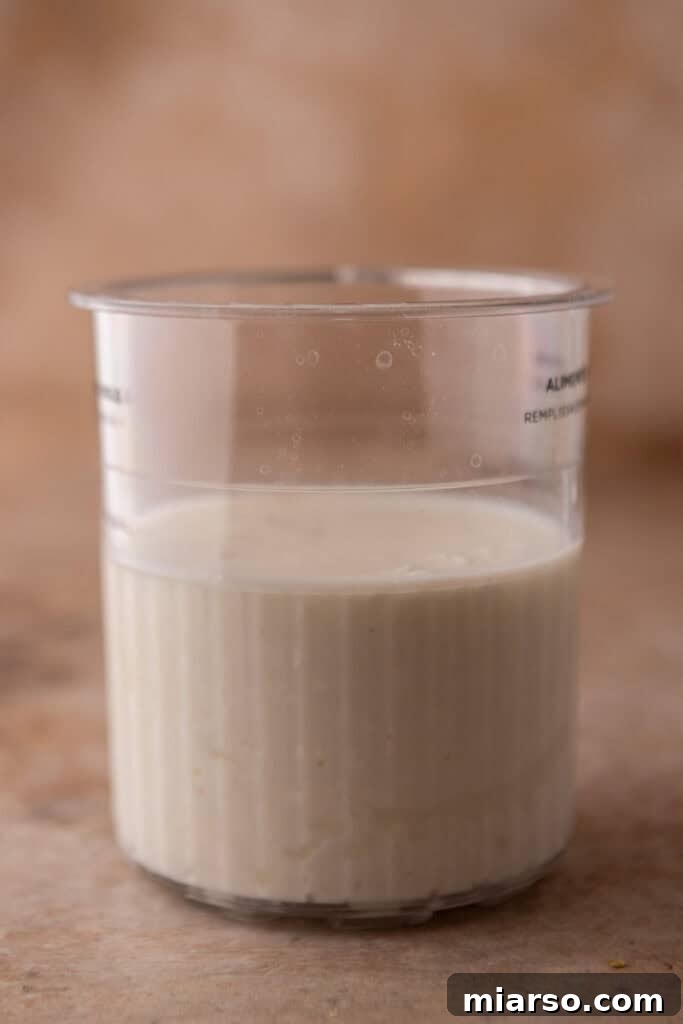 Ninja Creami pint container filled with the smooth cottage cheese base before freezing.