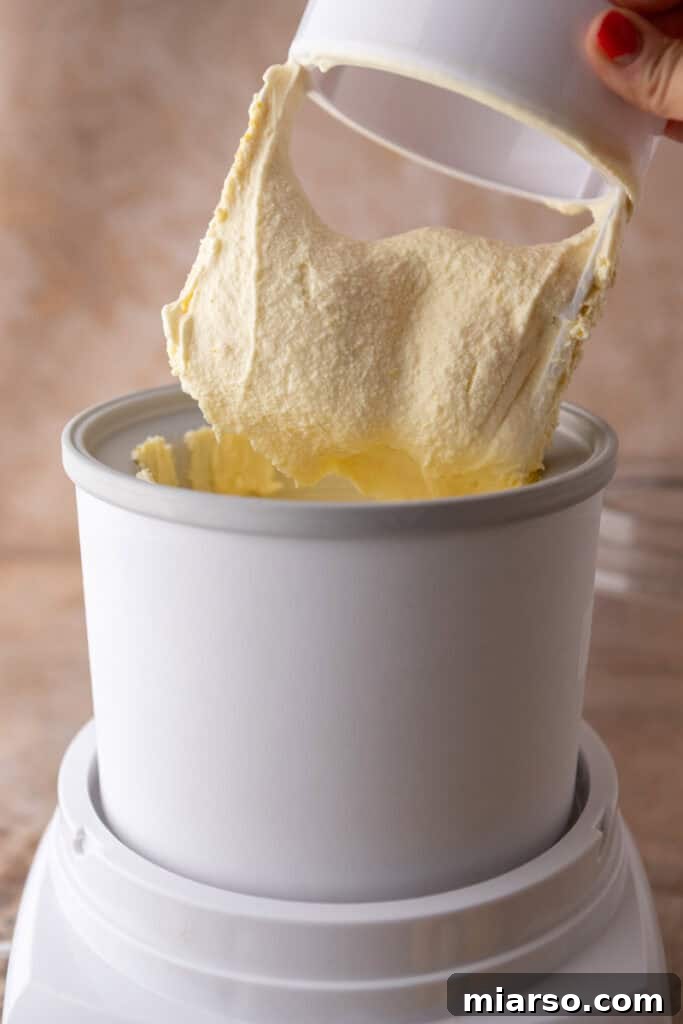 Soft-serve lemon ice cream being transferred from the churner to a container.
