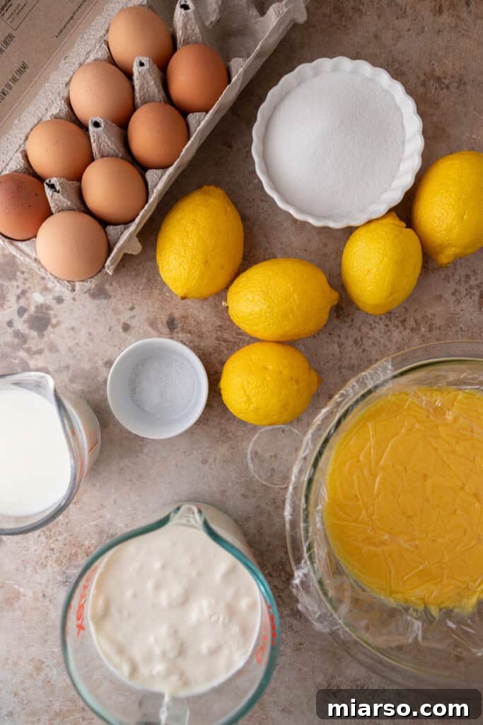 Fresh ingredients laid out for making lemon ice cream, including lemons, milk, cream, and eggs.