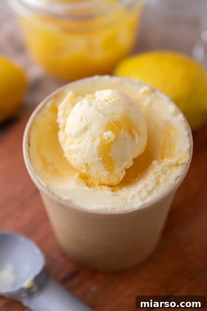 Delicious lemon ice cream, perfectly scooped and ready to be served in a serving bowl.