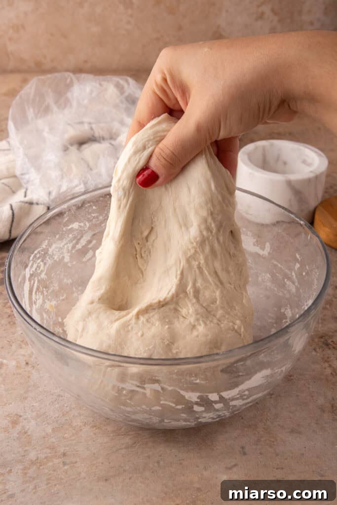 dough getting stretched and folded