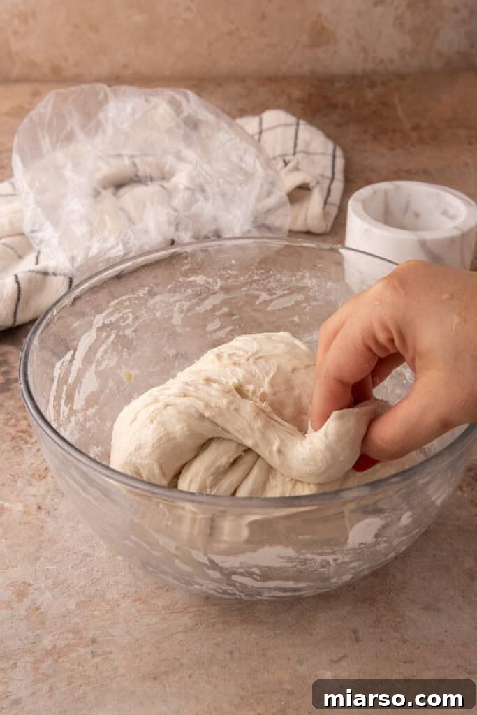 dough getting stretched and folded