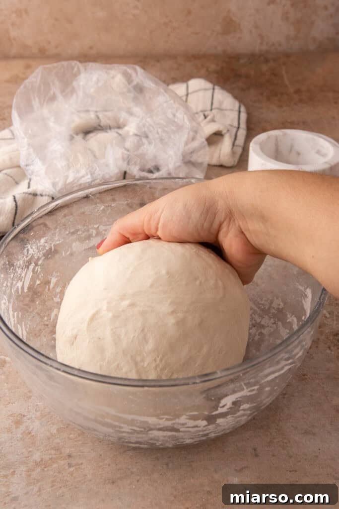 dough getting stretched and folded