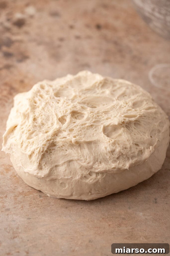 dough being flipped onto a table