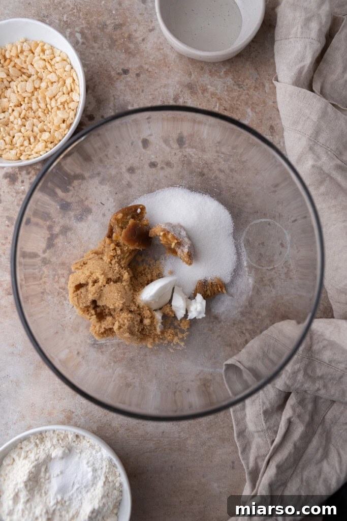 Butter and sugar being creamed together in a mixing bowl until light and fluffy.